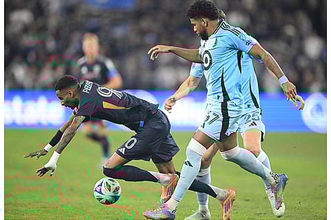 San Diego FC forward Amahl Pellegrino (90) goes down in front of Minnesota United midfielder Carlos Harvey (67) during the first half of MLS soccer's Western Conference semifinal in San Diego. 