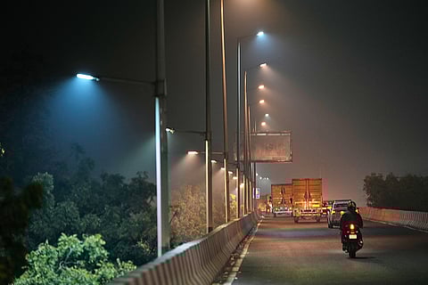 Traffic moves on a smog-filled night in New Delhi.