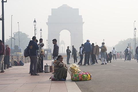 A vendor waits for customers at Kartavya Path during a smoggy winter morning, in New Delhi.