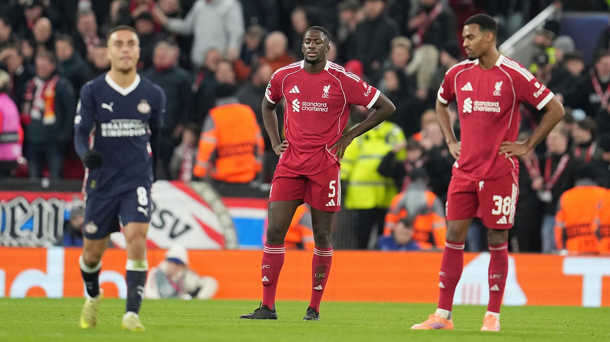Liverpool's Ibrahima Konate, centre, and Ryan Gravenberch, right, react after PSV's Couhaib Driouech scored his side's third goal during the Champions League opening phase soccer match between Liverpool and PSV in Liverpool, England, Wednesday, Nov. 26, 2025 - (AP Photo/Jon Super)