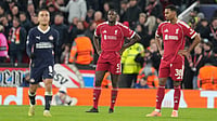(AP Photo/Jon Super) : Liverpool's Ibrahima Konate, centre, and Ryan Gravenberch, right, react after PSV's Couhaib Driouech scored his side's third goal during the Champions League opening phase soccer match between Liverpool and PSV in Liverpool, England, Wednesday, Nov. 26, 2025