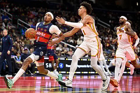 Washington Wizards guard Bilal Coulibaly (0) races toward the basket against Atlanta Hawks forward Jalen Johnson (1) during the first half of a Emirates NBA Cup basketball game  in Washington.