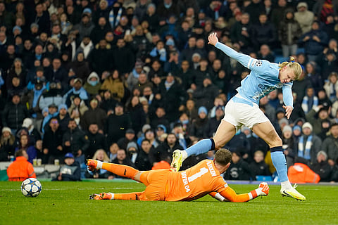 Manchester City's Erling Haaland has the ball take away from his by Leverkusen's goalkeeper Mark Flekken during the Champions League opening phase soccer match between Manchester City and Bayer Leverkusen in Manchester, England.