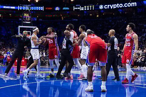 An incident on the court between Orlando Magic's Jalen Suggs, second from left, Philadelphia 76ers' Jabari Walker, third from right, and Andre Drummond, center, which leads to technicals and the ejection of Suggs during the first half of an NBA Cup basketball game in Philadelphia.