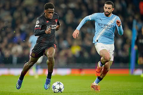 Leverkusen's Arthur, left, is challenged by Manchester City's Rayan Ait-Nouri during the Champions League opening phase soccer match between Manchester City and Bayer Leverkusen in Manchester, England.