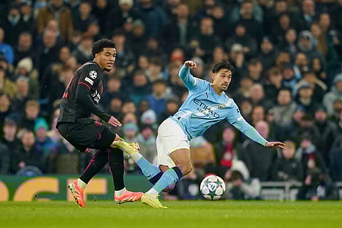 Leverkusen's Malik Tillman, left vies for the ball with Manchester City's Nico Gonzalez during the Champions League opening phase soccer match between Manchester City and Bayer Leverkusen in Manchester, England.