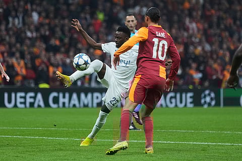 Union SG's Ousseynou Niang, left, fights for the ball with Galatasaray's Leroy Sane during the Champions League opening phase soccer match between Galatasaray and Union Saint-Gilloise, in Istanbul, Turkey.