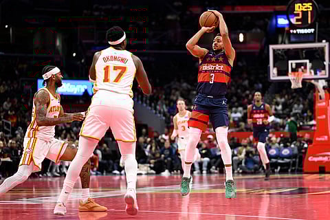 Washington Wizards guard CJ McCollum (3) launches a three point shot in front of Atlanta Hawks forward Onyeka Okongwu (17) during the first half of a Emirates NBA Cup basketball game in Washington.