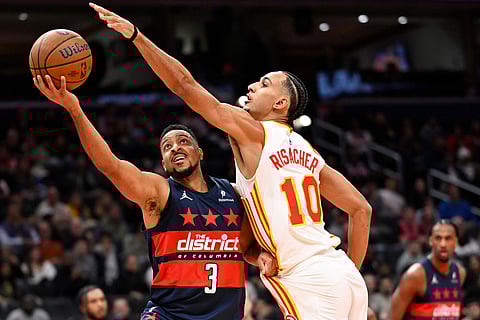 Washington Wizards guard CJ McCollum (3) attempts a shot against Atlanta Hawks forward Zaccharie Risacher (10) during the first half of an NBA Cup basketball game in Washington.