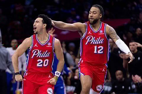 Philadelphia 76ers' Jared McCain (20) celebrates his three-point shot with Trendon Watford (12) during the first half of an NBA Cup basketball game against the Orlando Magic in Philadelphia.