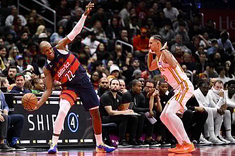 Washington Wizards forward Khris Middleton (22) reacts to a foul by Atlanta Hawks forward Zaccharie Risacher (10) during the second half of a Emirates NBA Cup basketball game  in Washington.