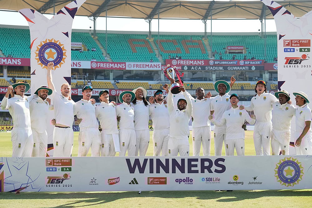 | Photo: AP/Anupam Nath : South Africa's cricket team celebrates with the trophy after winning the test series against India in Guwahati.