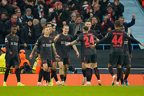 Leverkusen's Patrik Schick is congratulated by teammate Leverkusen's Aleix Garcia (24), after he scored his sides second gaol during the Champions League opening phase soccer match between Manchester City and Bayer Leverkusen in Manchester, England.
