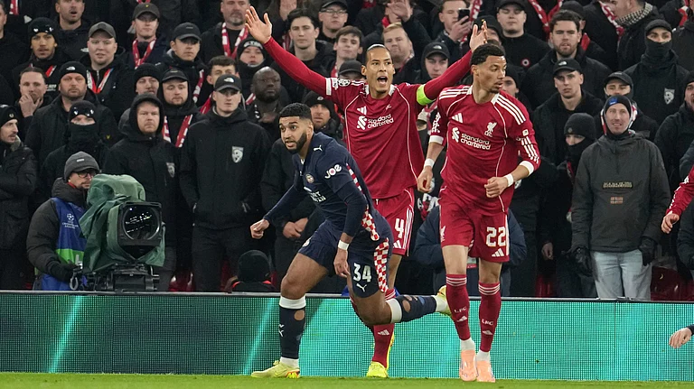 Liverpool's Virgil van Dijk, centre, reacts after missing a chance to score during the Champions League opening phase soccer match between Liverpool and PSV in Liverpool, England, Wednesday, Nov. 26, 2025 - (AP Photo/Jon Super)