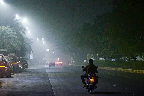 Commuters make their way amid smoggy weather, in Navi Mumbai.