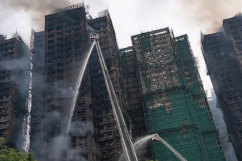 Firefighters work to extinguish a fire which broke out at Wang Fuk Court, a residential estate in the Tai Po district of Hong Kong's New Territories.