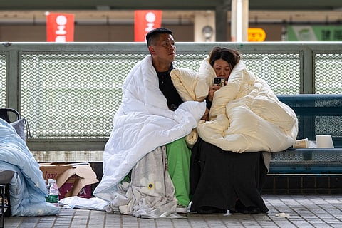 Residents rest at the fire scene at Wang Fuk Court, a residential estate in the Tai Po district of Hong Kong's New Territories.