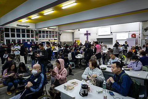 Residents rest at a temporary shelter after a fire broke out at Wang Fuk Court, a residential estate in the Tai Po district of Hong Kong's New Territories.
