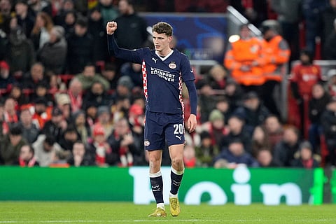PSV's Guus Til celebrates after scoring his side's second goal during the Champions League opening phase soccer match between Liverpool and PSV in Liverpool, England.