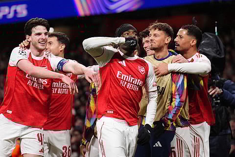 Arsenal's Noni Madueke, center, celebrates after scoring his side's second goal during the Champions League opening phase soccer match between Arsenal and Bayern Munich in London.