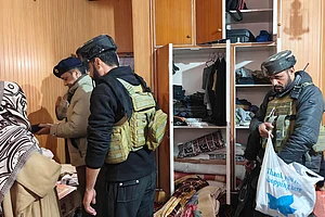 | Photo: PTI : Police with CRPF personnel carry out a search at the residence of a person linked to banned Jamaat-e-Islami, in Pulwama. J&K Police carried out raids at multiple locations across the Kashmir Valley as part of its crackdown on the banned Jamaat-e-Islami (JeI), officials said.