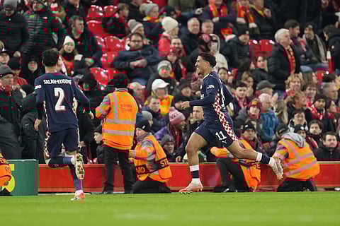 PSV's Couhaib Driouech, right, celebrates after scoring his side's fourth goal during the Champions League opening phase soccer match between Liverpool and PSV in Liverpool, England.
