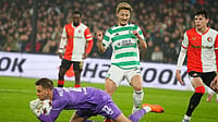 Feyenoord 1-3 Celtic Highlights, UEFA Europa League: Bhoys Come From Behind To Seal Win In Amsterdam | Photo: AP/Peter Dejong : Celtic's Daizen Maeda jumps to avoid colliding with Feyenoord's goalkeeper Timon Wellenreuther who saves during the UEFA Europa League opening phase match on November 27, 2025.