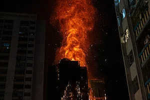 | Photo: AP/Chan Long Hei : Flames engulf a building after a fire broke out at Wang Fuk Court, a residential estate in the Tai Po district of Hong Kong's New Territories.