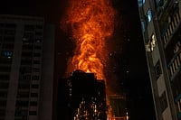 | Photo: AP/Chan Long Hei : Flames engulf a building after a fire broke out at Wang Fuk Court, a residential estate in the Tai Po district of Hong Kong's New Territories.