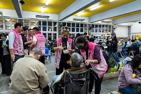 Residents rest at a temporary shelter after a fire broke out at Wang Fuk Court, a residential estate in the Tai Po district of Hong Kong's New Territories.