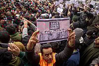 J&K Govt Cornered As Open Merit Quota Row Intensifies ZUMA Wire : A Kashmiri man holds a placard during a protest outside the chief minister’s official residence in Srinagar against Jammu and Kashmir’s reservation policy.