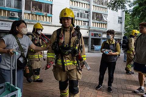 Residents cheer up the firefighters near the scene of a fire  at Wang Fuk Court, a residential estate in the Tai Po district of Hong Kong's New Territories.