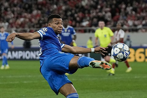 Real Madrid's Kylian Mbappe attempts a shot on goal during the Champions League opening phase soccer match between Olympiacos and Real Madrid in Piraeus port, near Athens, Greece.