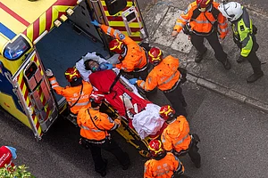 AP Photo/Chan Long Hei : Health workers vacuating woman, hong kong fire.