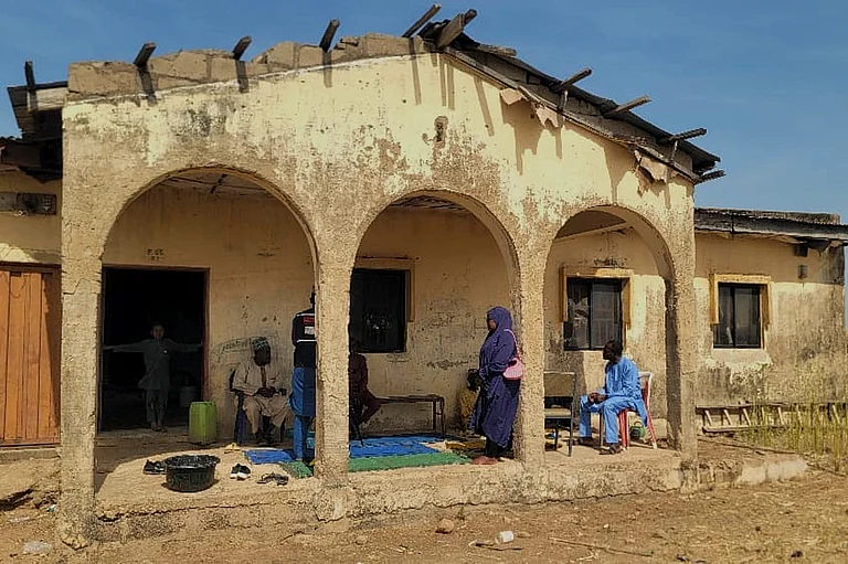 Mourners gather at the house of Hassan Yakubu Makuku, vice principal of the Government Girls Comprehensive Secondary School, where gunmen on Monday attacked the school dormitory, abducted schoolgirls, and killed him, in Kebbi, Nigeria, Tuesday, Nov. 18, 2025 - Tunde Omolehin