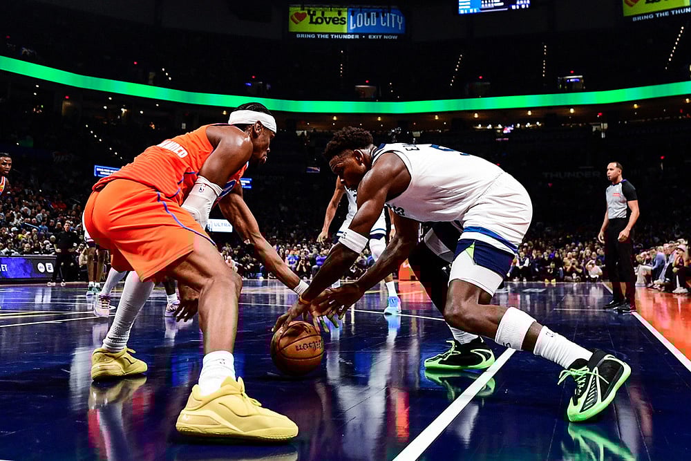Oklahoma City Thunder guard Shai Gilgeous-Alexander (2) goes for the free ball against Minnesota Timberwolves guard Anthony Edwards (5) during the second half of an Emirates NBA Cup basketball game in Oklahoma City.  - | Photo: AP/Gerald Leong
