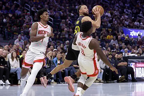 Golden State Warriors' Stephen Curry is called for an offensive foul against Houston Rockets' Aaron Holiday during the second half of an Emirates NBA Cup basketball game in San Francisco. 