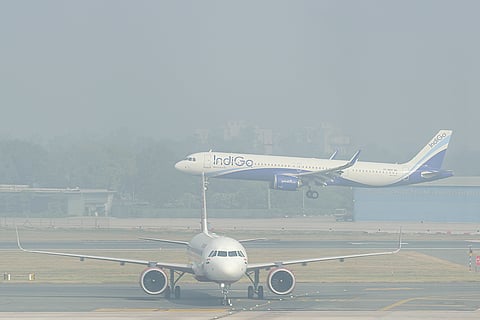 Aircraft seen amid low visibility conditions due to smog at Indira Gandhi International Airport, in New Delhi.