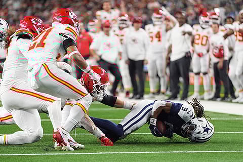 Dallas Cowboys wide receiver KaVontae Turpin (9) recovers a fumble by teammate George Pickens during the second half of an NFL football game against the Kansas City Chiefs in Arlington, Texas. 
