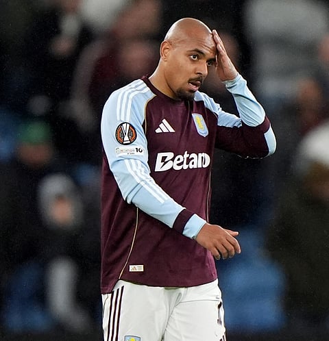 Aston Villa's Donyell Malen reacts after being hit with an object from the away fans during the Europa League soccer match between Aston Villa and Young Boys in Birmingham, England.