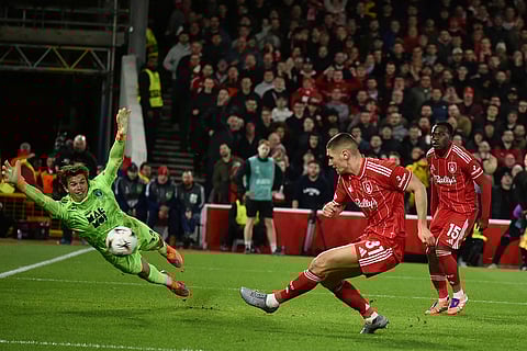 Nottingham Forest's Nikola Milenkovicshoot and score his sides third goal, which was given after a VAR review, during the Europa League opening phase soccer match between Nottingham Forest and Malmo in Nottingham, England.