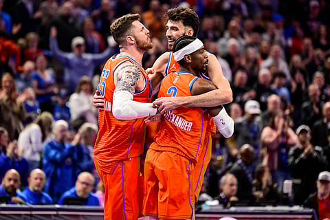 Oklahoma City Thunder center/forward Chet Holmgren (7), center, celebrates with Oklahoma City Thunder center/forward Isaiah Hartenstein (55) and Oklahoma City Thunder guard Shai Gilgeous-Alexander (2) during the second half of an Emirates NBA Cup basketball game in Oklahoma City. 