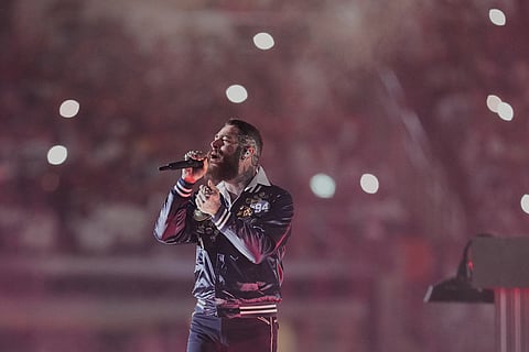 Post Malone performs during halftime of an NFL football game between the Kansas City Chiefs and the Dallas Cowboys in Arlington, Texas. 