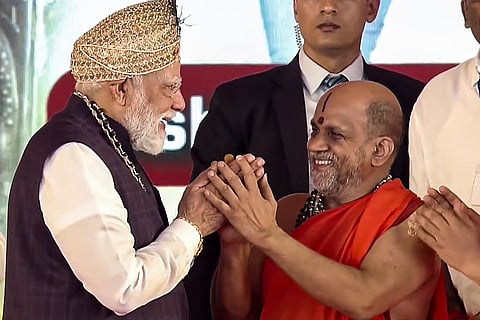 Prime Minister Narendra Modi with Paryaya Puttige Mutt seer Sri Sugunendra Theertha Swamiji during 'Laksha Kantha Gita Parayana' programme at Sri Krishna Mutt, in Udupi, Karnataka. 
