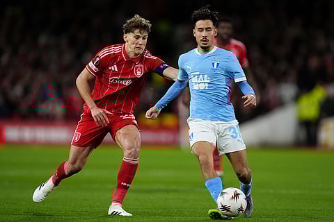Nottingham Forest's Ryan Yates, left, and Malmo's Adrian Skogmar in action during the Europa League opening league phase soccer match between Nottingham Forest and Malmo FF in Nottingham, England.