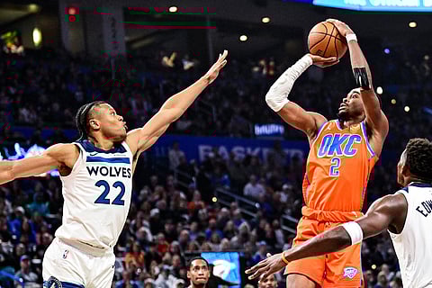Oklahoma City Thunder guard Shai Gilgeous-Alexander (2) shoots against Minnesota Timberwolves guard Jaylen Clark (22) during the first half of an Emirates NBA Cup basketball game in Oklahoma City.