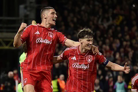 Nottingham Forest's Nikola Milenkovic, left celebrates with teammates after scoring his sides third goal during the Europa League opening phase soccer match between Nottingham Forest and Malmo in Nottingham, England.