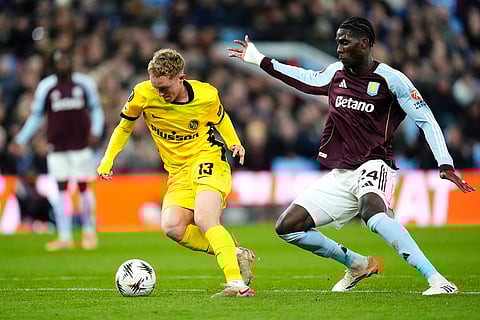 Aston Villa's Amadou Onana, right, and Young Boys' Dominik Pech, left, challenge for the ball during the Europa League soccer match between Aston Villa and Young Boys in Birmingham, England.