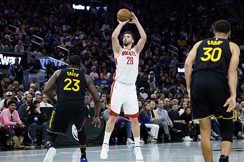 Houston Rockets center Alperen Şengün shoots past Golden State Warriors forward Draymond Green during the second half of an Emirates NBA Cup basketball game in San Francisco. 