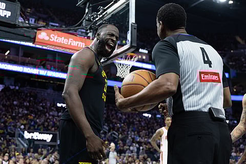 Golden State Warriors forward Draymond Green interacts with referee Sean Wright during the second half of an Emirates NBA Cup basketball game against the Houston Rockets in San Francisco. 